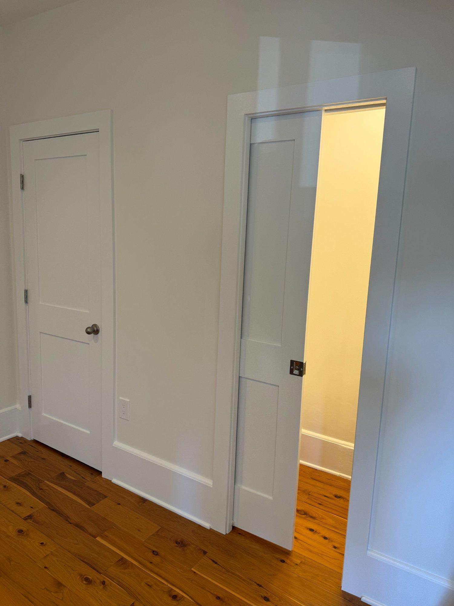 New interior pocket door with frosted glass panel and refinished hardwood floors