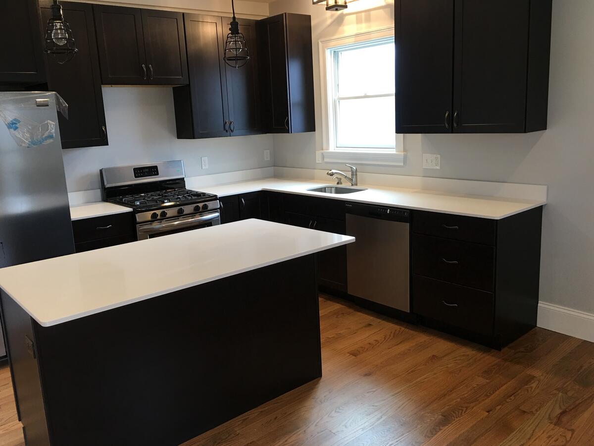 Renovated kitchen in Medford MA two-family home by North Heritage Construction