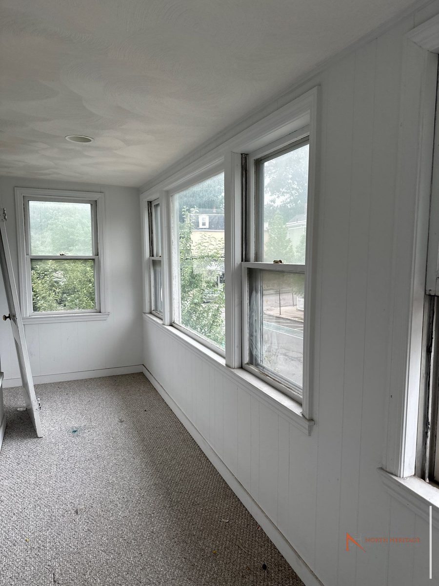 Somerville home before renovation - interior enclosed porch windows