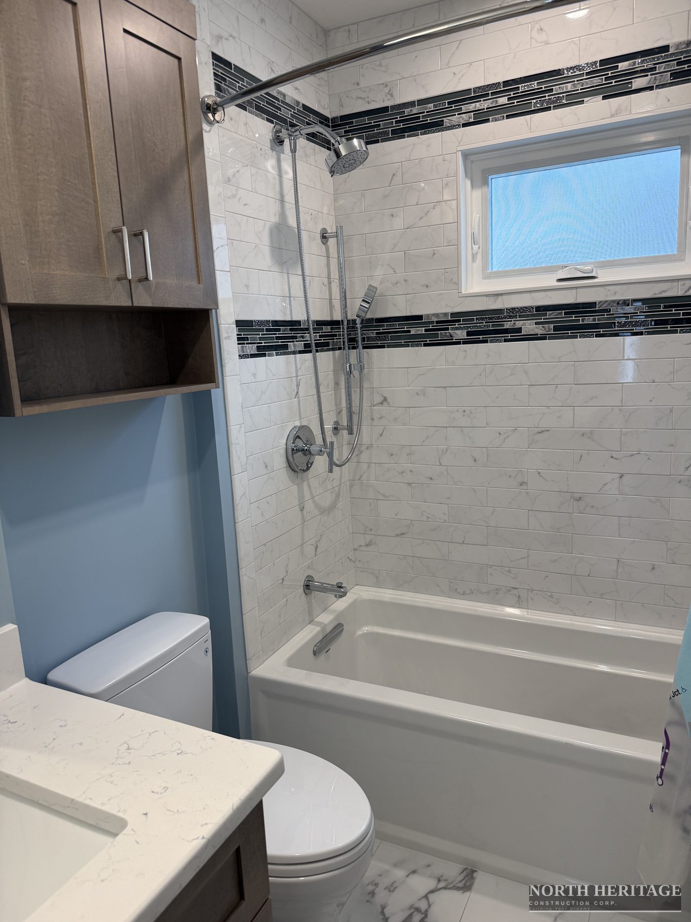 Finished bathroom with marble tile shower and custom vanity Somerville MA