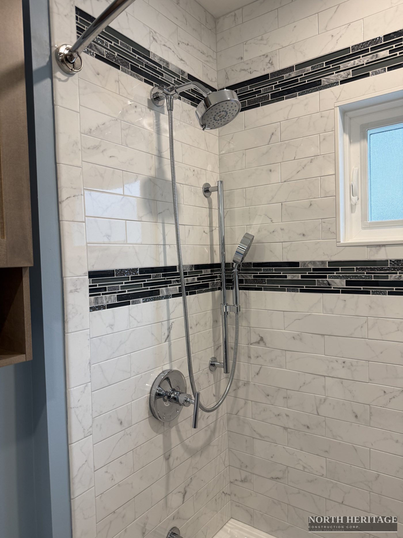 Carrara marble subway tile shower with glass mosaic accent border